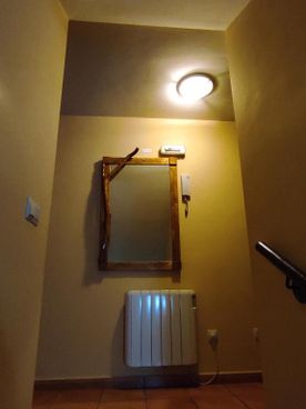 Casa Rural los Alisos pasillo con espejo sobre radiador